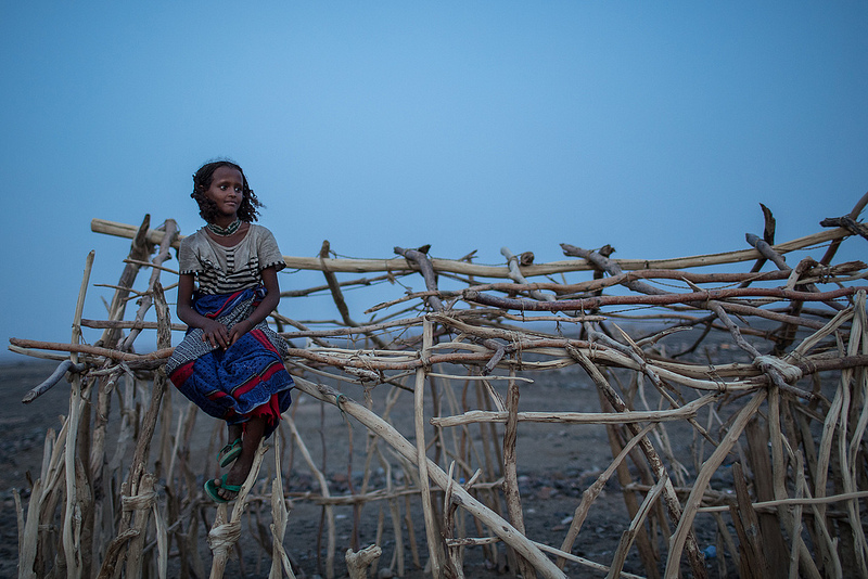 A young woman sitting on a structure made of branches - Highlights of Djibouti