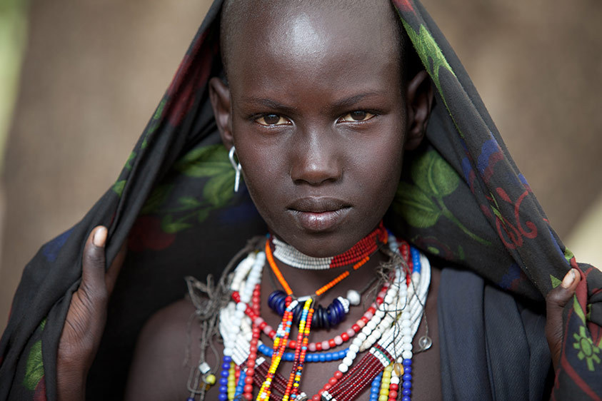 A young woman with extravagant beads around her neck - Omo Valley & Timket Festival
