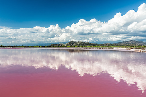 View of pink water salt lake and the mountains surrounding it