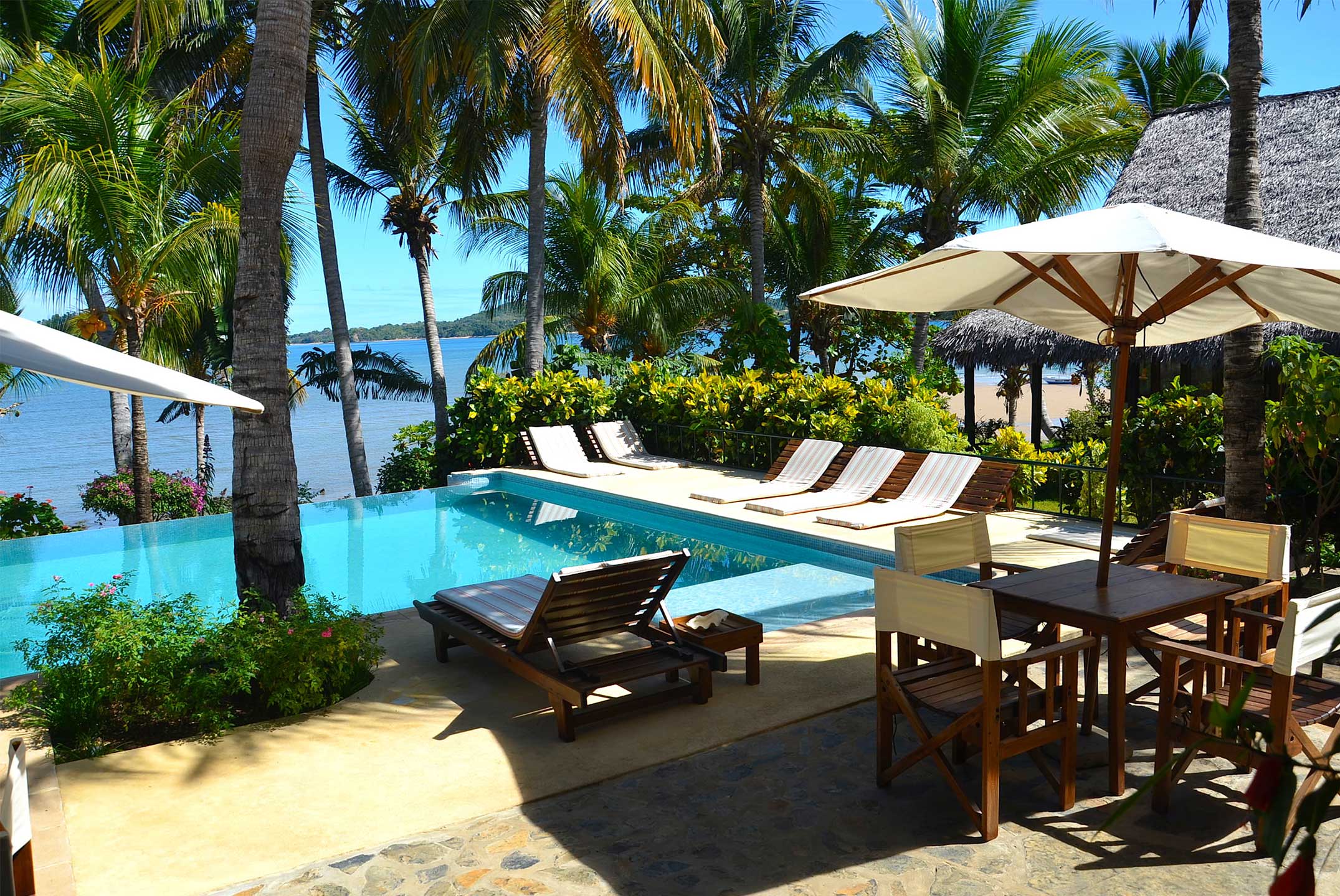 Lounge chairs surrounding the pool of Vanila Hotel & Spa