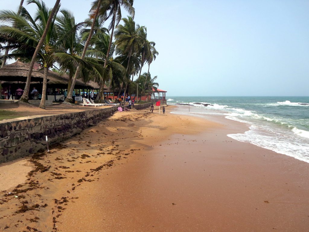 A beach with waves crashing on the shore of a resort - Ghana Beach History & Nature