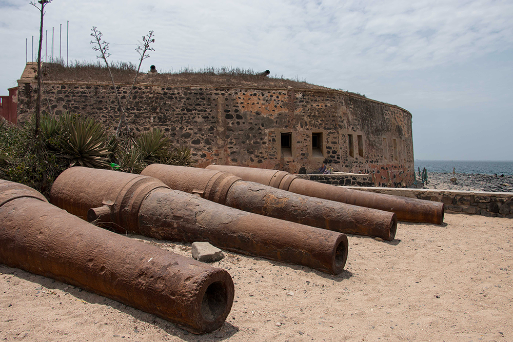 Ancient cannons lying on the beach of a historical site
