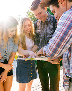 Student travellers looking at map deciding where to go