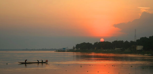 A boat being silhouetted against a sunset - Tour of Central African Republic