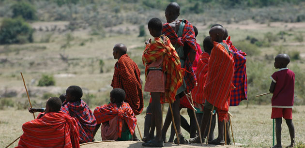 Children dressed in various shades of red plaid - Kenya Maasai Mara - Kenya Trails Safari