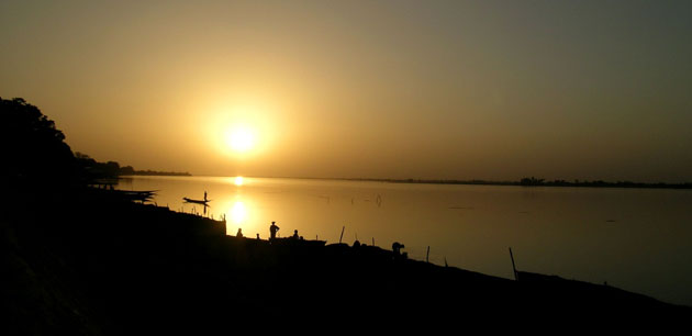 People silhouetted against a sunset