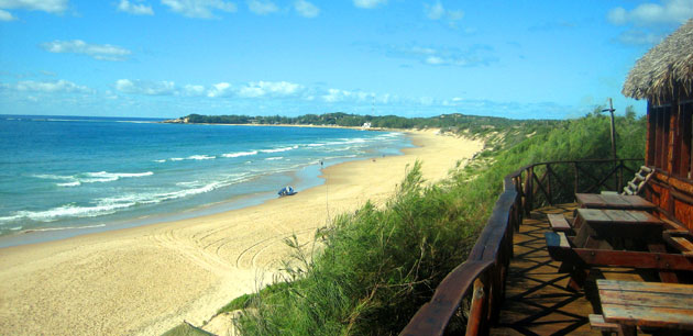 A beach view with waves crashing onto the sand - Tour of Mozambique