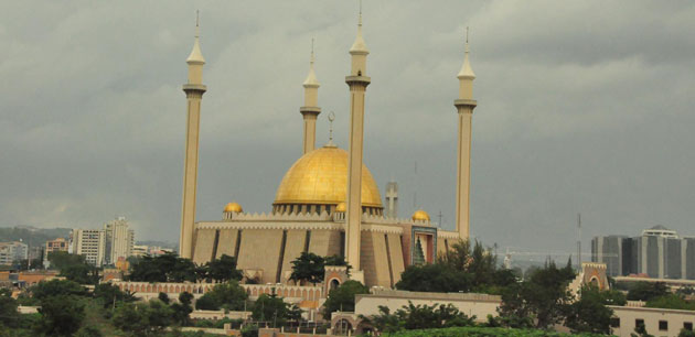 A white building with a large golden dome on top
