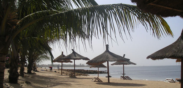 A beach with large umbrellas - Backroads Of Senegal