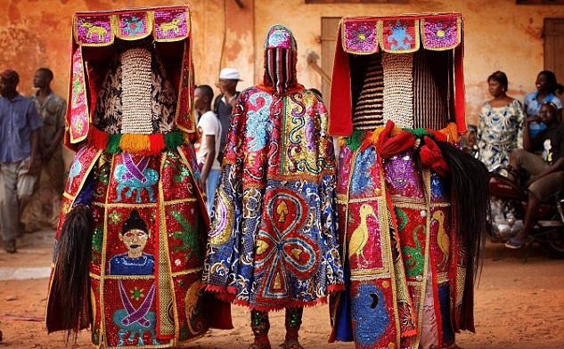 A group of people with highly detailed embellishments on their clothing - Annual Ouidah Voodoo Festival