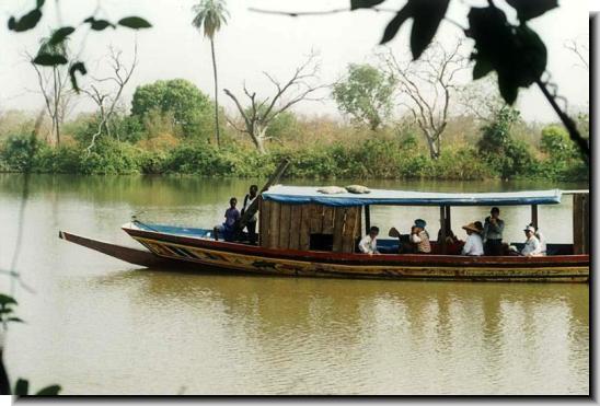 A boat filled with people going down a river